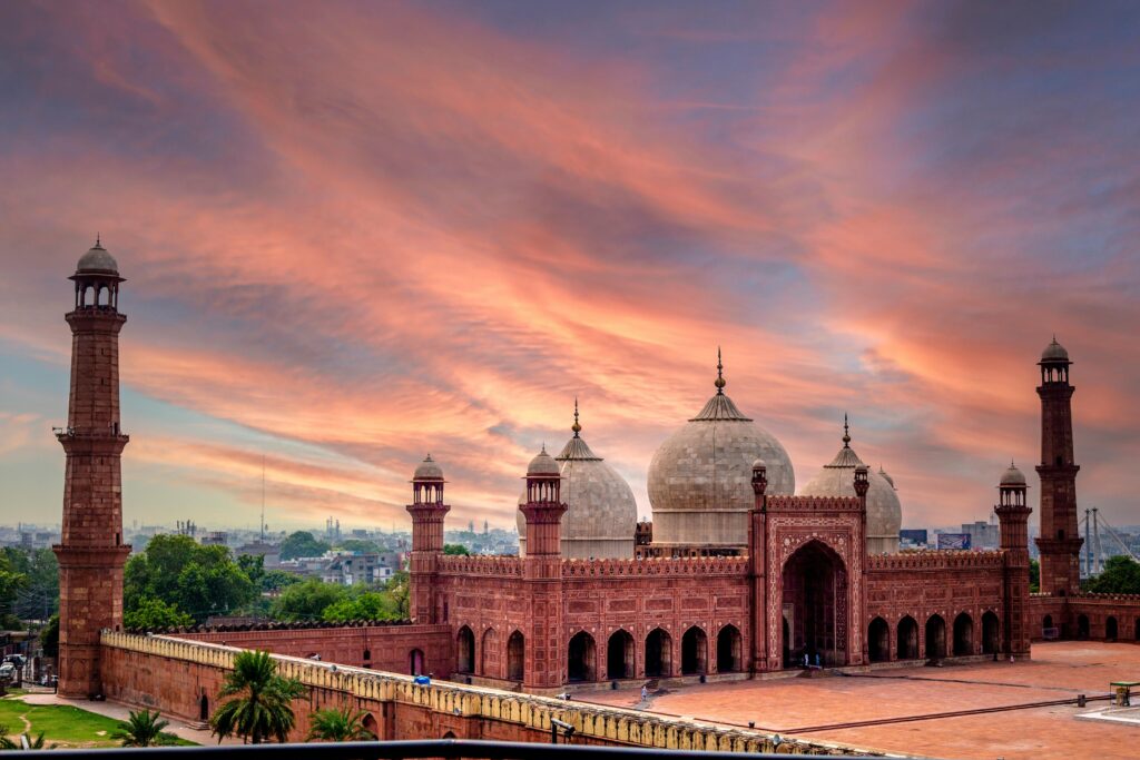 A stunning sunset casting warm hues over the iconic Badshahi Mosque in Lahore, Pakistan.